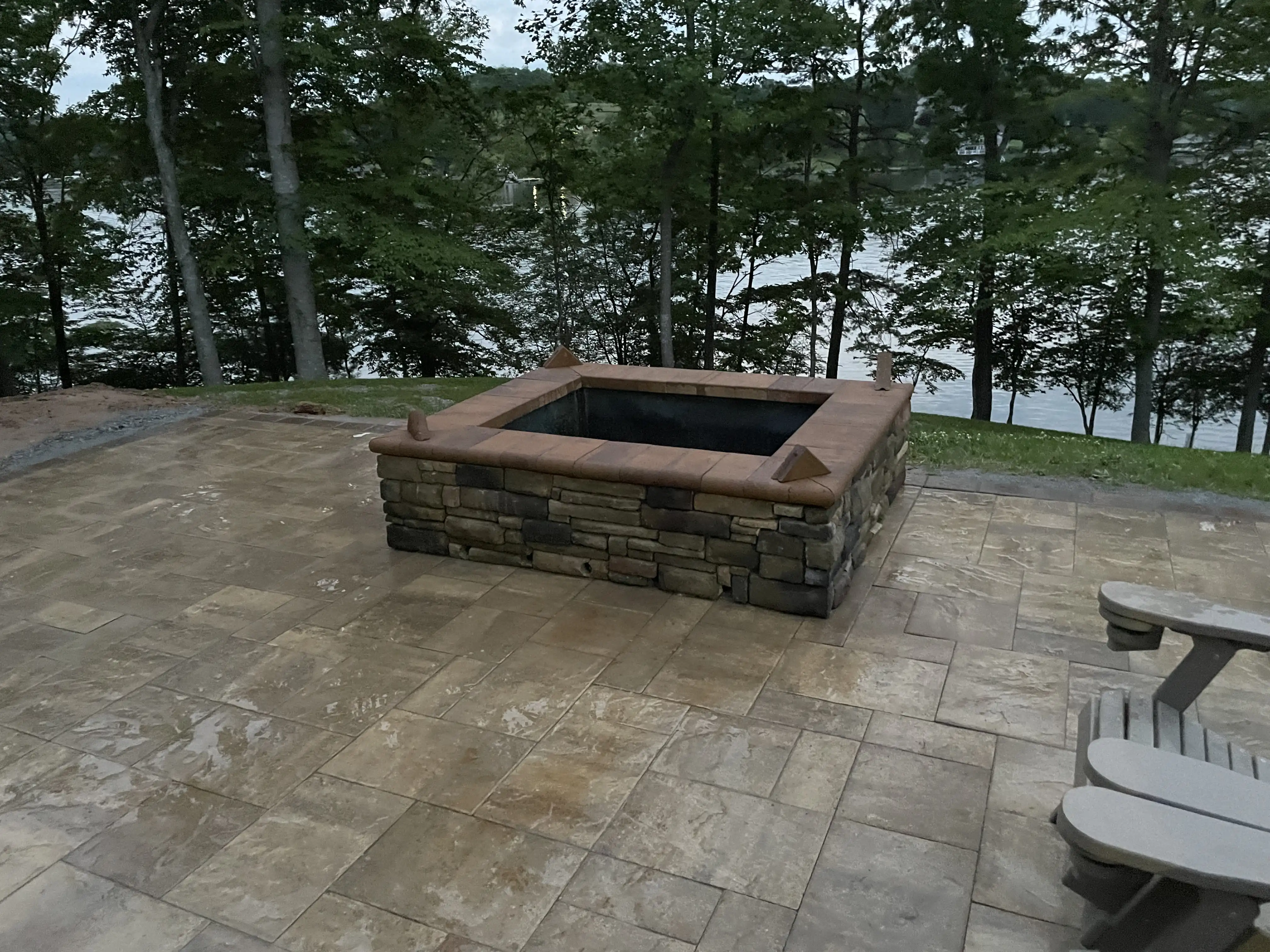 Lakefront fire pit with stone seating wall