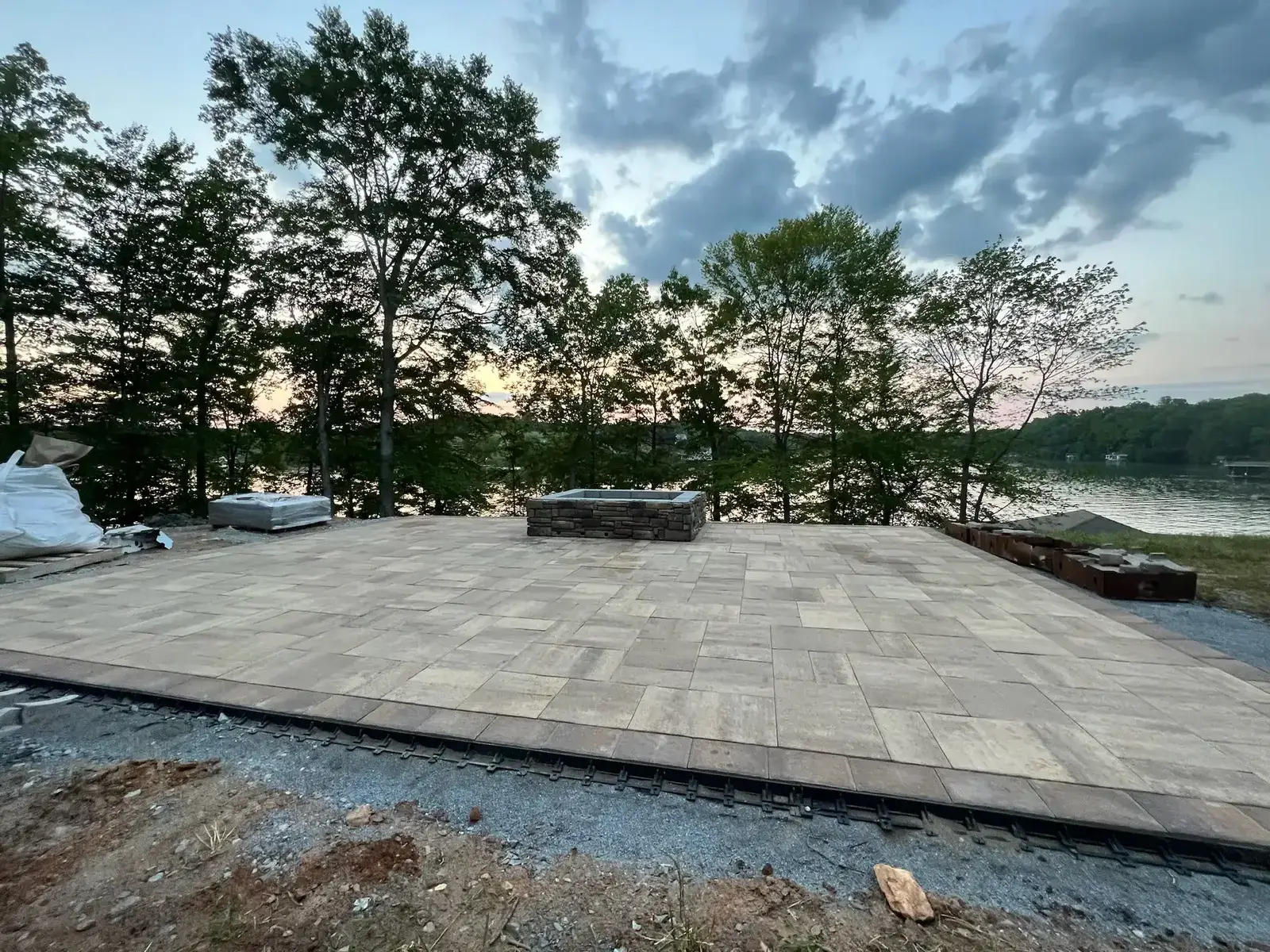 Waterfront paver patio with fire pit at Smith Mountain Lake — Ridgestone Excavating