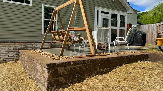 Large patio with curved sitting wall