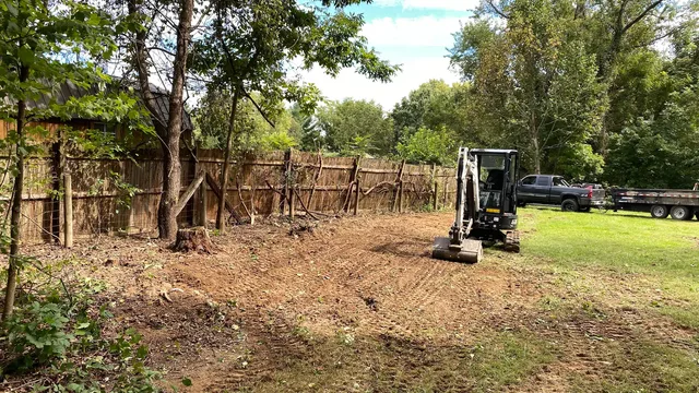 Excavator clearing residential lot