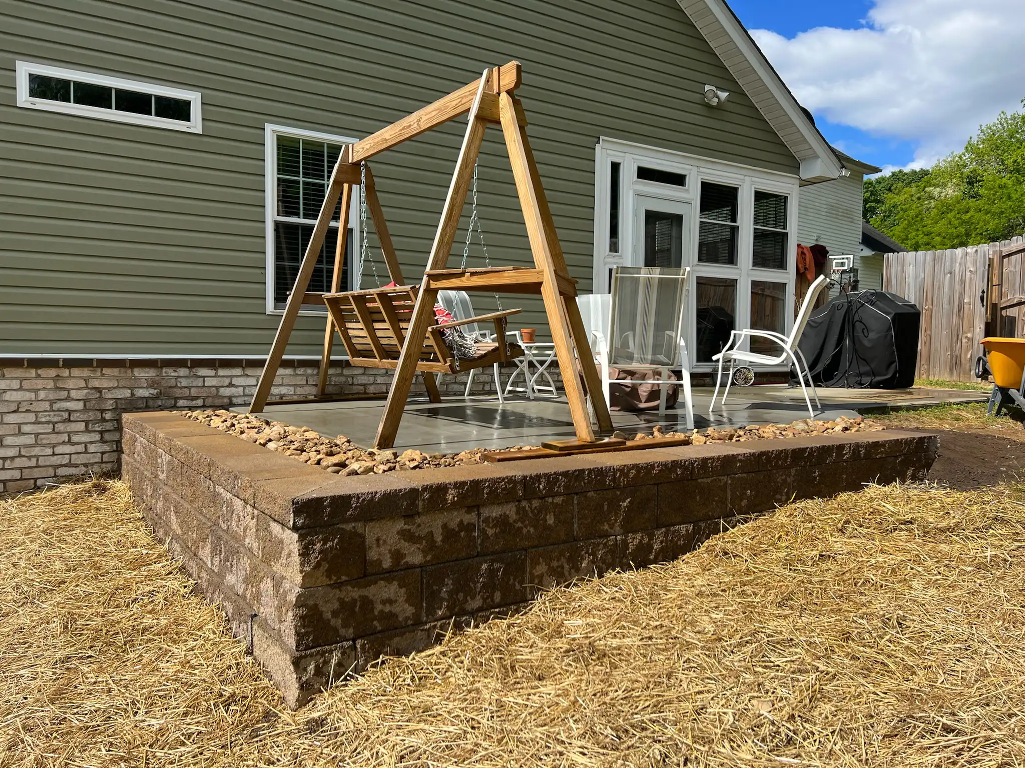 Large patio with curved sitting wall